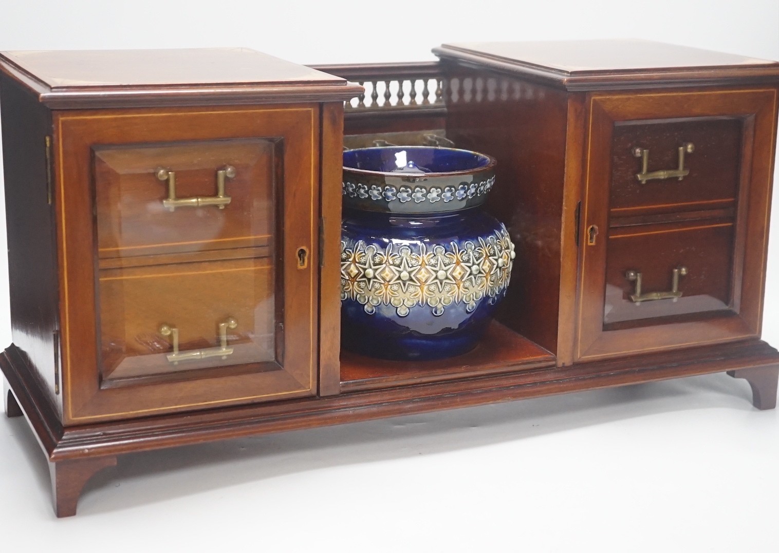 An Edwardian inlaid mahogany smoker's compendium with Doulton Lambeth stoneware tobacco jar, 52cm wide